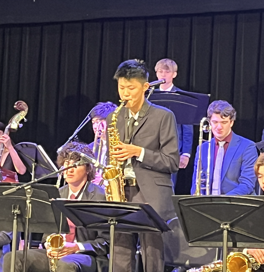 Alan playing alto saxophone on stage